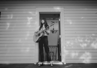 Madi Diaz, singer/songwriter, holding a guitar