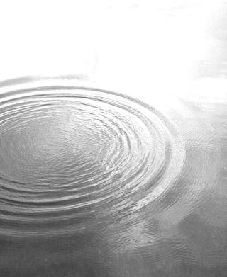 Black and white ripples in water symbolizing how small actions create wide impact
