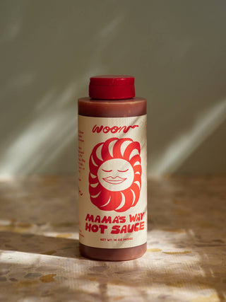 Woon Mama's Way Hot Sauce bottle side view showing product information and ingredient details on cream label