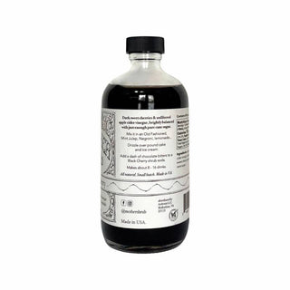 Back label of MOTHER Black Cherry shrub bottle showing ingredients list and product description on white background