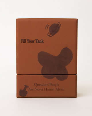 Two stacked rust-colored boxes of Questions People Are Never Honest About card game, featuring Fill Your Tank text and illustrated icons on front