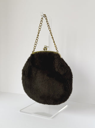Back view of round vintage espresso faux fur evening bag with gold chain handle and kiss-lock closure on display stand