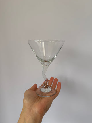 Single vintage martini glass with twisted stem held in hand against white background, showing size and detail of spiral design