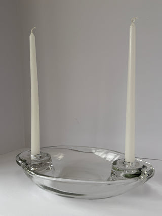 Side view of vintage glass centerpiece with white taper candles showing the elevated spiral candle holder design