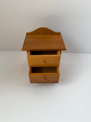 Vintage wooden jewelry box dresser with two open drawers displaying interior storage compartments, curved decorative top, and honey-toned wood finish