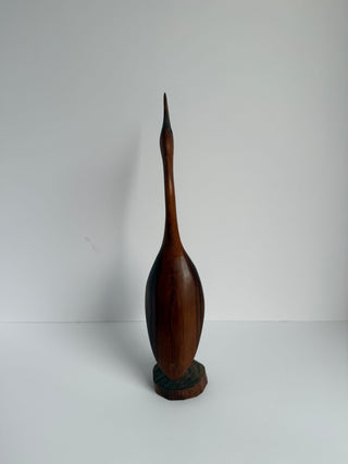 Rear view of vintage carved wood crane figurine on stand showing full body profile and natural wood finish