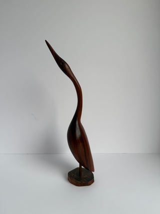 Front angled view of mid-century wooden crane sculpture showing streamlined body and graceful posture