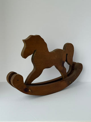 Vintage wooden rocking horse angled view showing curved rocker base and handcrafted construction