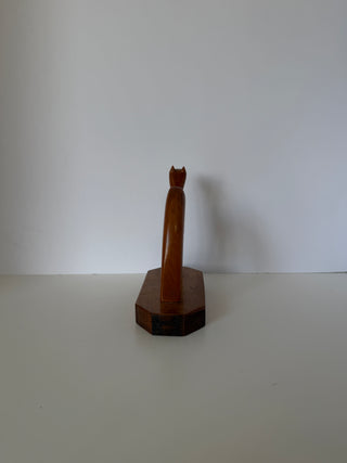 Rear three-quarter view of vintage wooden camel sculpture showing back profile and octagonal base construction