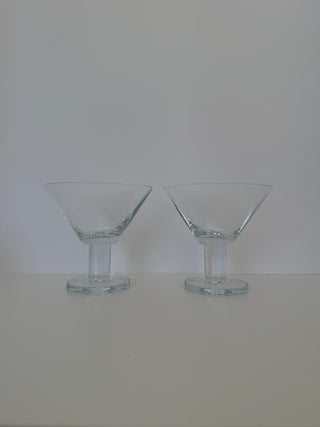Front view of pair of vintage martini glasses with bold stems and geometric angular bowls side by side