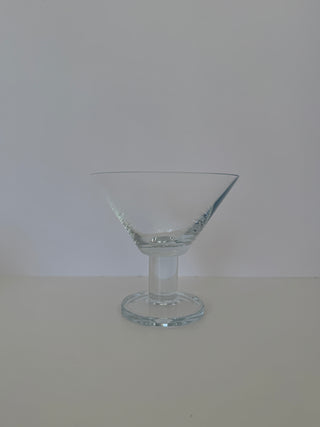 Single vintage martini glass showing side profile of wide conical bowl and distinctive pedestal stem base
