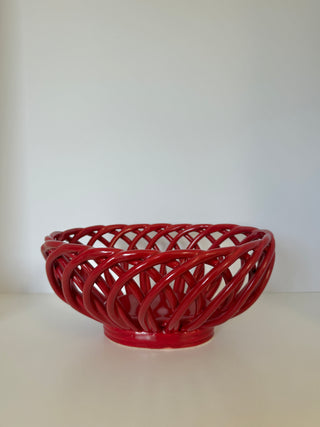 Vintage red ceramic lattice fruit bowl with intricate woven pattern and footed base, front view on white background