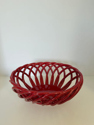Red ceramic lattice bowl showing diagonal angle of open weave design and solid center base with glossy finish