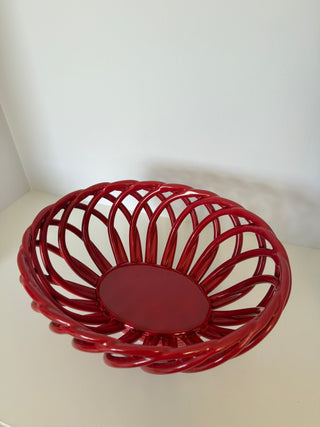 Top interior view of vintage red lattice ceramic bowl displaying radial spiral pattern and circular solid base