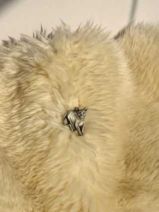 Vintage Rawcliffe pewter cat brooch displayed on cream-colored fur background showing detailed sitting cat design
