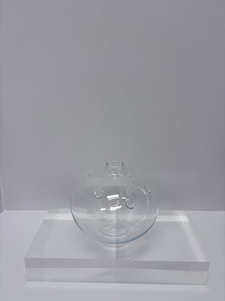 Vintage clear glass laboratory flask with multiple openings displayed on clear acrylic pedestal against white background