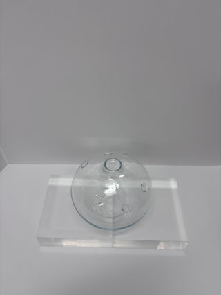 Front view of vintage glass scientific flask showing spherical body and top opening on transparent display stand