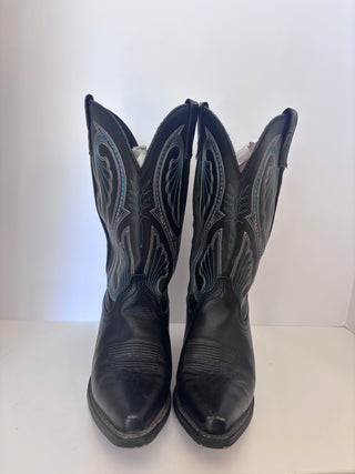 Front facing view of vintage black cowboy boots displaying pointed toe and symmetrical stitching patterns