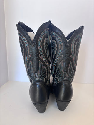 Back view of vintage black leather Western boots showing heel detail and decorative stitching