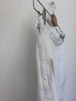 Side angle detail of vintage white cotton shorts showing tailored construction, zipper closure, and pleated front