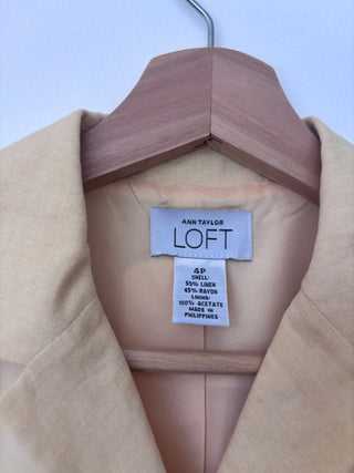 Close-up detail of Ann Taylor Loft label inside vest collar showing size 4P and fabric content: 55% linen, 45% rayon with acetate lining
