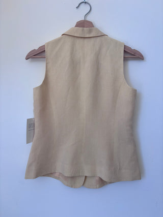 Back view of vintage beige linen vest on hanger showing clean lines, center back seam, and relaxed fit