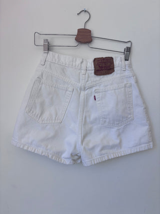 Back view of vintage white Levi's denim shorts showing brown leather patch and back pockets