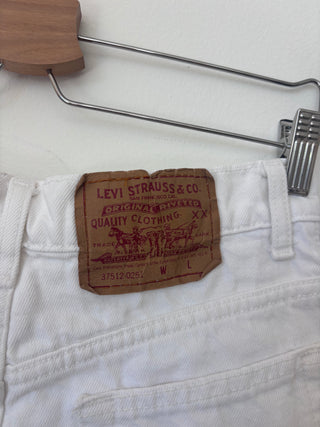 Close-up detail of Levi Strauss & Co. leather patch on white denim shorts showing San Francisco branding