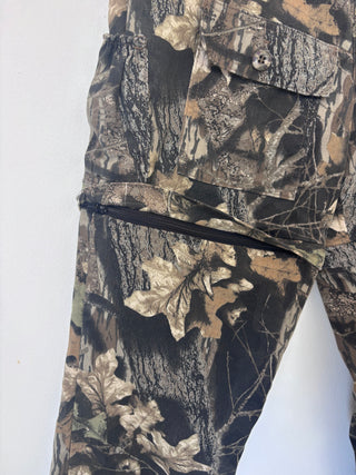 Close-up detail of zippered cargo pocket on thigh of vintage camo pants