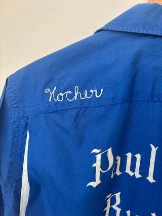 Close-up of upper back embroidery showing 'Kocher' in script and gothic lettering on vintage work shirt
