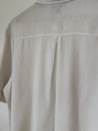 Back view detail of vintage cream linen shirt showing upper back yoke seam and relaxed fit drape