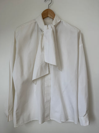Vintage Ellen Tracy ivory silk blouse with pussy bow tie on wooden hanger against white wall