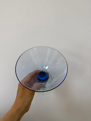 Overhead view into the vintage blue martini glass showing the wide conical bowl interior and cobalt blue stem detail at center