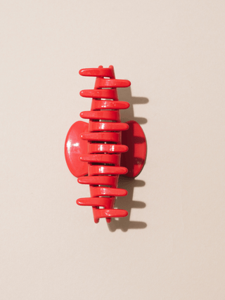 bottom view of hair claw on neutral background