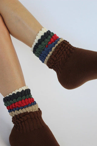 Na Nin Fifi Socks in different colors layered and styled on feet against on a white background