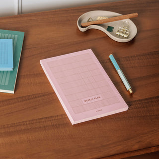 Planer sitting on desk with stationery accessories 