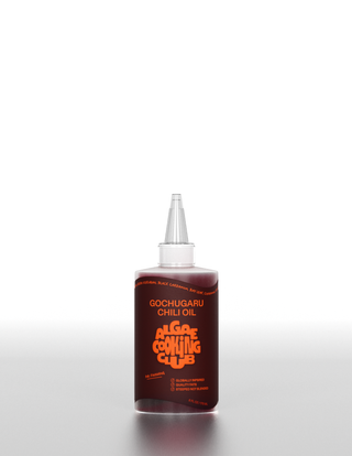 Single bottle of Gochugaru Chili Oil showing deep red-brown color through clear bottle with detailed label visible
