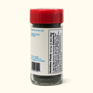 Woon Sea Moss Seasoning jar side panel displaying nutrition facts and ingredient list with barcode, red cap visible on top