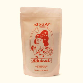 Front of Woon Hibiscus tea package in pink kraft paper pouch with red illustrated design of woman in traditional dress, hibiscus flowers, and product details