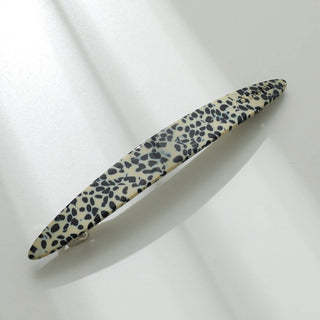 Leopard print French barrette in cream base with black spots covering entire surface